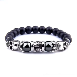 Black onyx skull beaded bracelet flat lay view with dual silver skull charms and natural stone beads
