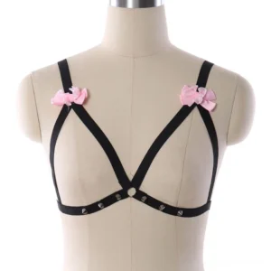 Black pentagram body harness with pink bows and metal rivets front view on mannequin