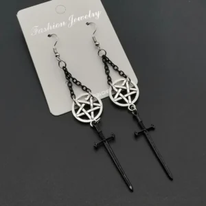 Black and silver gothic pentagram sword dangle earrings flat lay on dark background with jewelry tag showing chain details