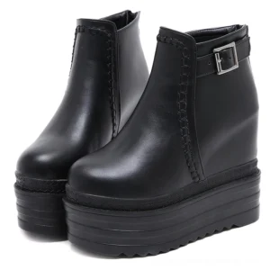 Pair of black platform ankle boots with buckle straps and decorative stitching, front double view on white background