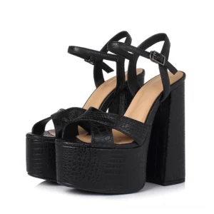 Black platform buckle sandals with chunky square heel, front three-quarter view showing ankle strap and open toe design
