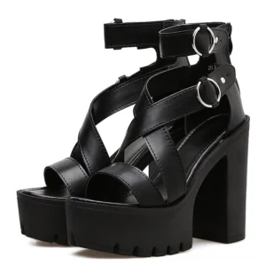 Black platform gladiator sandals with crisscross buckle straps and metal ring details, front paired view