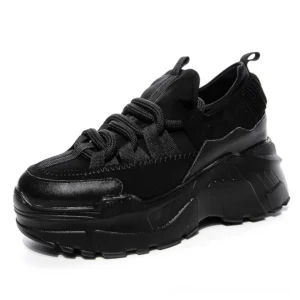 Black women's platform leather sneakers with thick lug sole and lace-up closure, front three-quarter studio view