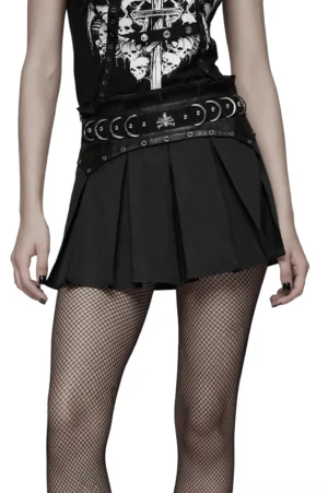 Black pleated gothic mini skirt with metal cross hardware and leather waistband, front three-quarter view on model