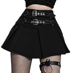 Black pleated gothic mini skirt front waist view with dual adjustable leather buckle straps and silver hardware, modeled with fishnet stockings