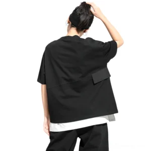 Black gothic pleated t-shirt back view displaying relaxed fit, patch pocket detail, and layered hemline construction