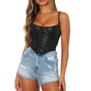 Black PU leather gothic corset crop tank top worn by model with front hook closure and spaghetti straps, paired with distressed denim shorts