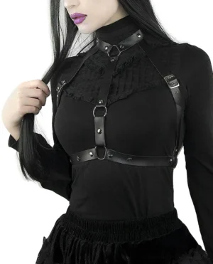 Black PU leather chest harness worn by female goth model with dark hair, showcasing three-quarter front view with silver metal O-ring hardware details