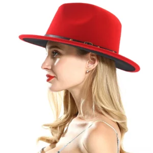 Two-tone gothic fedora profile view showcasing red crown, black brim, and leather belt accent detail