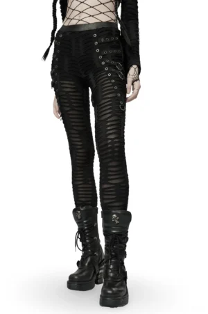 Black ripped gothic leggings with metal rivets front three-quarter view on model, featuring strategic mesh cutouts and industrial hardware details