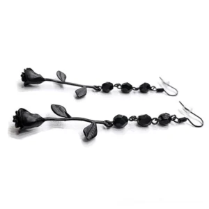 Black rose dangle earrings top-down overhead view - geometric faceted beads paired with matte rose leaf drops alternative jewelry