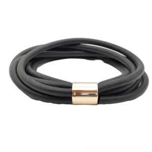 Multi-strand black rubber gothic bracelet overhead flat lay showing rose gold metal clasp detail