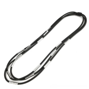 Multi-layered black rubber gothic necklace flat lay side view showing knotted closure and matte texture