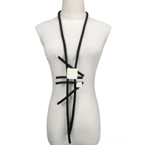 Black rubber gothic statement necklace with geometric wooden pendants displayed on dress form mannequin, front view