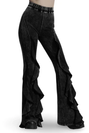 Women's black acid-washed flared gothic pants with layered ruffled edges, side view on model
