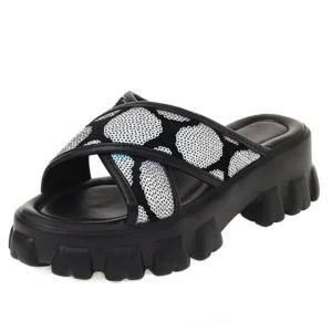 Black sequin platform slide sandals with holographic cross-strap design and chunky lug outsole, three-quarter side view showcasing gothic aesthetic