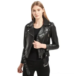 Black sheepskin leather moto jacket with asymmetrical zipper front and notched collar, worn by model on white background - women's gothic biker style