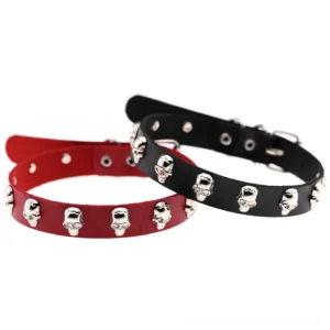 Pair of black leather skull chokers flat lay showing D-ring buckle closures and adjustable strap with punched holes