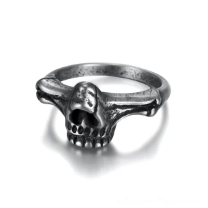 Black stainless steel skull ring with detailed skeleton texture, frontal studio view showing intricate bone engravings