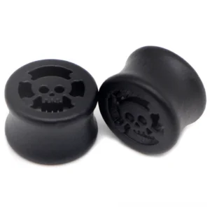 Black skull star ear gauge tunnel plug stretcher in matte finish, showing carved skull design and smooth polished surface, multiple sizes available for gothic ear stretching