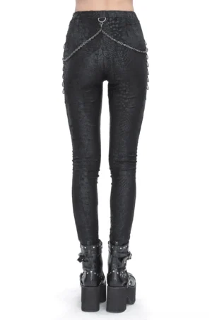 Black snake print leggings rear view worn on model displaying back waist chain embellishments and serpent scale texture