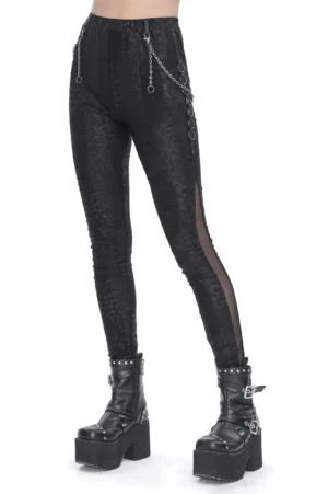 Black snake print skinny leggings worn on model, left front three-quarter view showing reptile pattern and waist chain hardware with mesh leg panel
