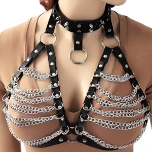 Black spiked PU leather chest harness with layered metal chains and silver hardware on female model, front view
