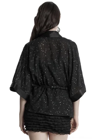 Black star print gothic cape full back view on model, paired with ruffled mini skirt, demonstrating draped silhouette and constellation pattern