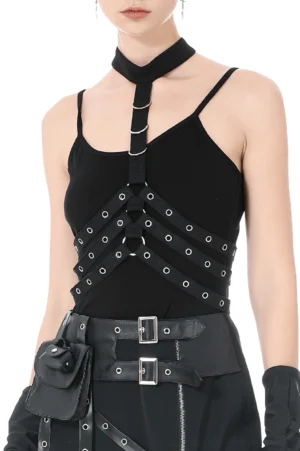 Black strappy chest harness with metal eyelets worn by female model showing front upper-body cage design