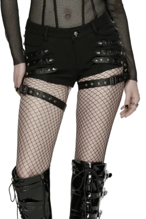 Black low-rise gothic shorts with studded mesh front panel and adjustable leg harness, front three-quarter view on model