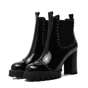 Black studded gothic ankle boots front double angle view, chunky platform block heel, patent leather with rivet trim