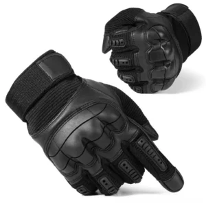 Black hard knuckle tactical combat gloves with reinforced knuckle guards, oblique front view on studio white background