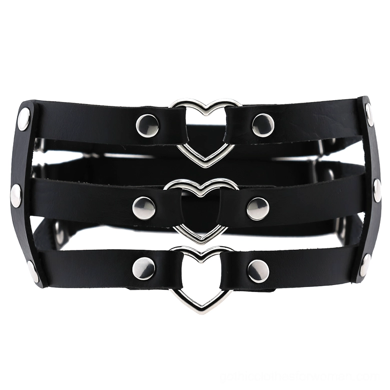 Black PU leather elastic leg harness with triple straps and silver metal heart decoration, front flat lay view