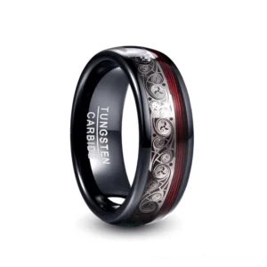 Black tungsten carbide gothic ring with ethnic inlay pattern and red accent stripe, front oblique view showing inner engraving detail