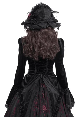 Gothic black velvet blouse back view displaying lace-up corset back design and asymmetric velvet hem on female model with brown hair