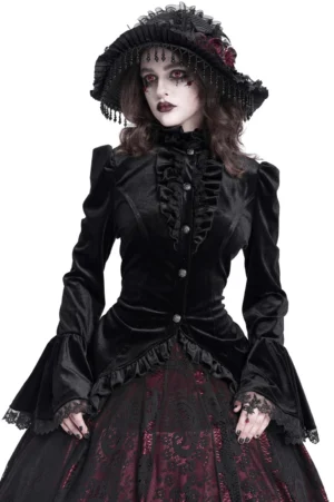 Black velvet gothic blouse front three-quarter view showing ruffled lace collar, bell sleeves, and button front placket on female goth model