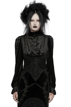 Black velvet gothic blouse front view with rose buttons, ruffled bell sleeves, and cinched waist on model – Victorian-inspired stand collar design