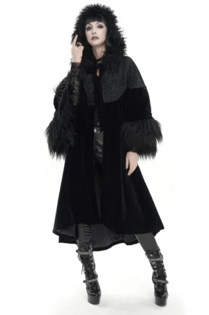 Black velvet gothic cape with faux fur hood worn by female model, front full-body view showing wide sleeves and dramatic silhouette