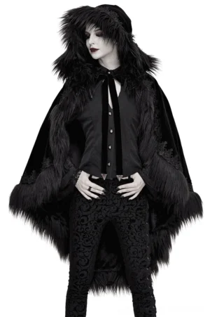 Black velvet gothic hooded cloak with faux fur trim worn by female goth model in front three-quarter view, showcasing dramatic draping and hood silhouette