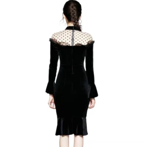 Black velvet gothic dress back view featuring exposed mesh yoke and slim fitted silhouette, rear full-body model shot on white background