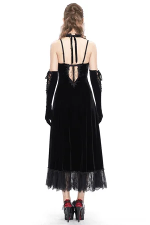 Black velvet gothic dress back view on model, showcasing open back design with tie straps and floral lace hem detail