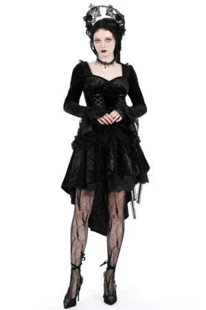 Black velvet gothic dress with high-low dovetail skirt worn by model, front view showing sweetheart neckline and lace-trimmed details