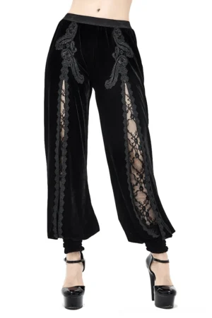 Women's black velvet gothic flared pants with floral lace embroidery front view on model