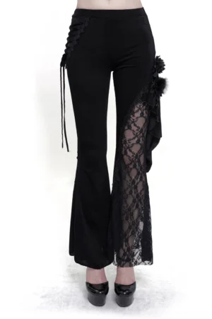 Black velvet gothic flared pants with side lace-up accents front view on model, showing high waist and lace leg panel details