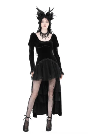 Black velvet gothic high-low dress with square neckline, puffed sleeves, and lace hem worn by model with dark goth styling