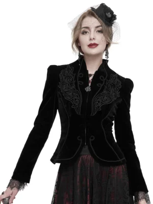Black velvet gothic jacket front view with lace cuffs and embroidered chest detail on model wearing vintage veil headpiece