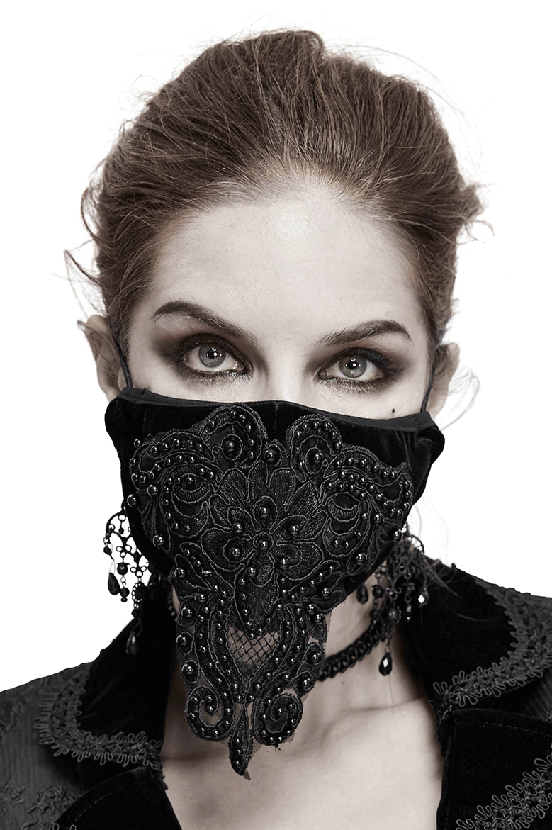 Black velvet gothic lace face mask with beaded appliqué worn by model, front close-up view