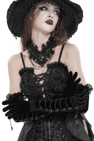 Black velvet opera gloves with lace cuffs and metal chain details worn on model, three-quarter front view showcasing the fitted silhouette and gothic elegance