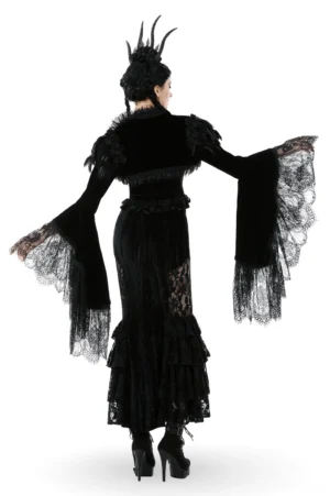 Back view of cropped black velvet gothic shrug with feather shoulder accents and layered lace sleeve cuffs paired with ruffled lace skirt