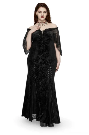 Black velvet off-shoulder gothic maxi dress with lace-up corset back worn by plus-size model, front three-quarter view showing damask velvet texture and lace sleeves